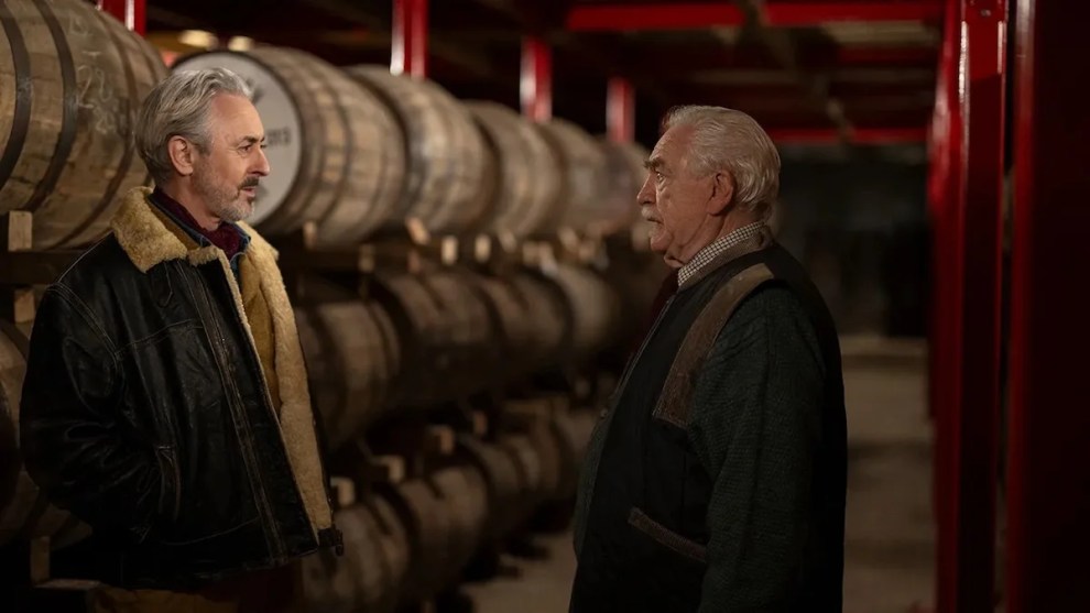 Alan Cumming (left) and Brian Cox (right) have a serious conversation together in a distillery in a still from "Glenrothan."