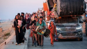 Displaced Palestinians evacuating southbound from Gaza City travel on foot and by vehicle along the coastal road in Nuseirat in the central Gaza Strip on September 13, 2025